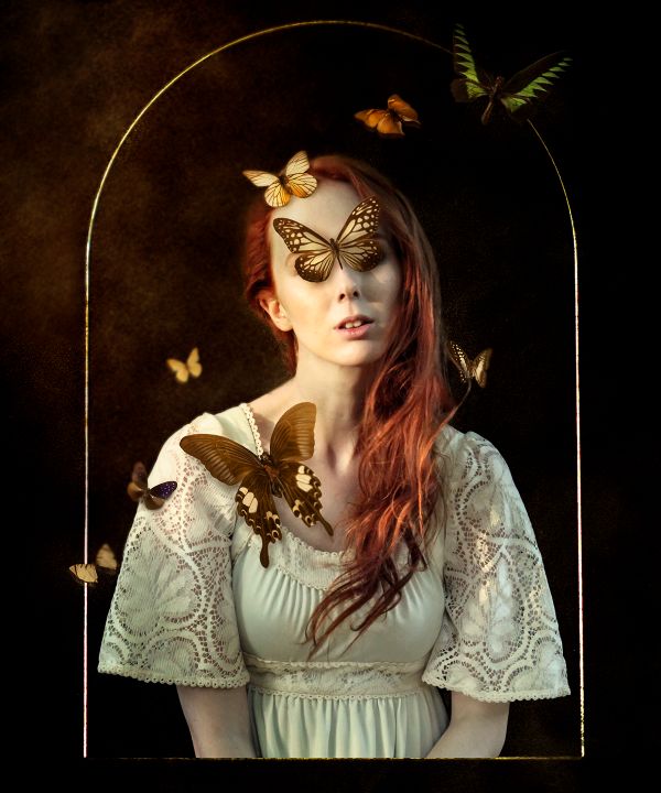 A stylised photograph of a woman inside a glass dome, surrounded by butterflies